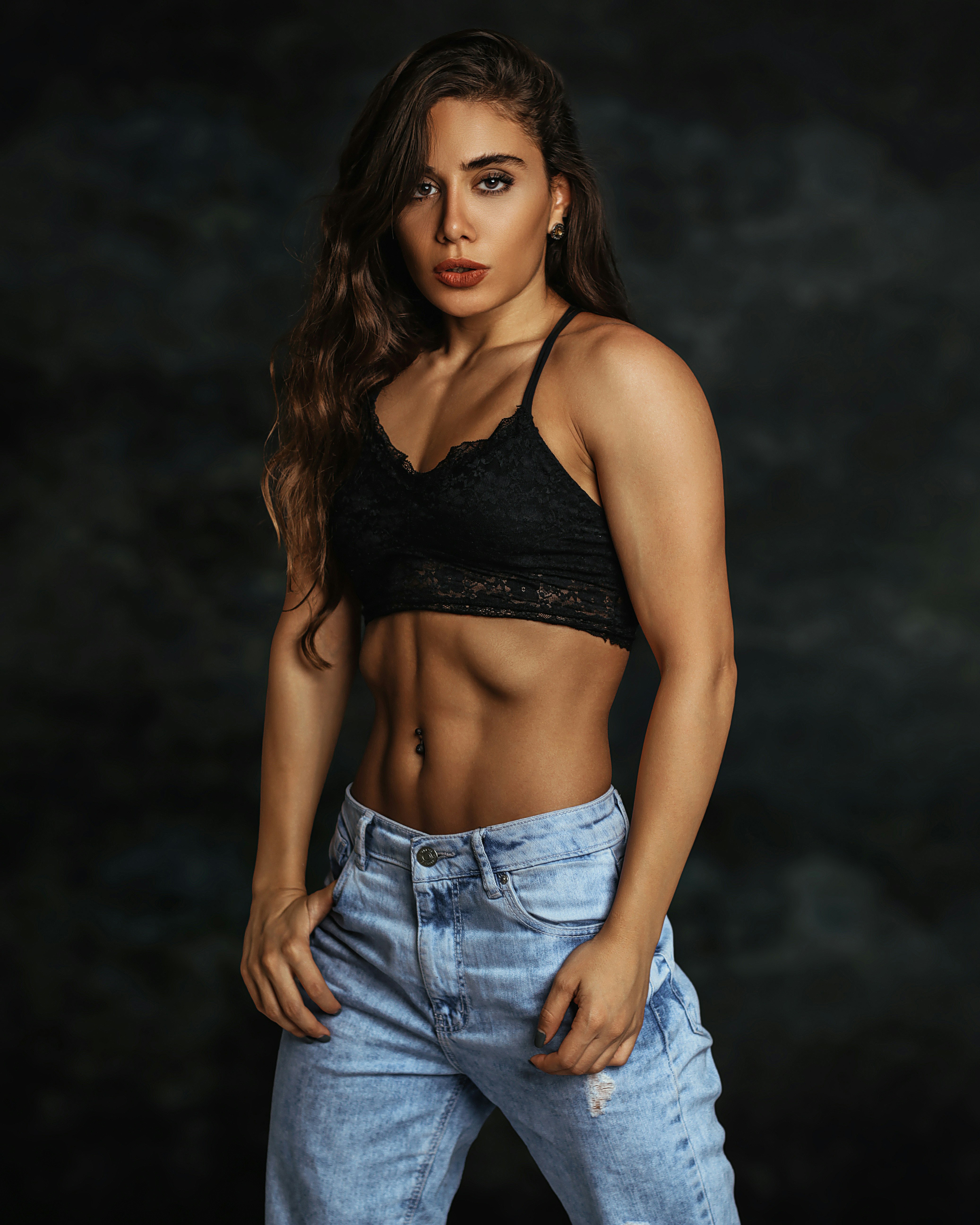 woman in black brassiere and blue denim jeans